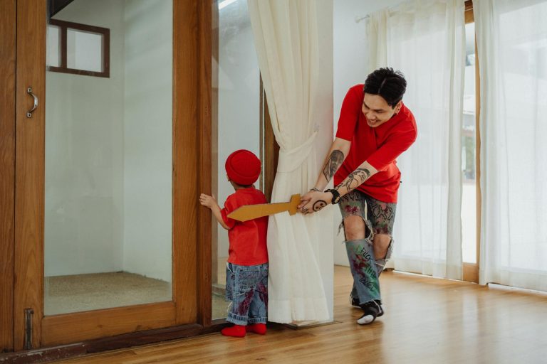 A joyful father and son playing together indoors, showcasing vibrant family bonding.